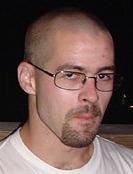 1995 Ford Bronco - A man with glasses and a goatee is pictured from the chest up.