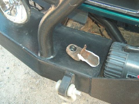 1995 Ford Bronco - Close-up of a vehicle's front bumper assembly, showing off-road modifications and a winch.