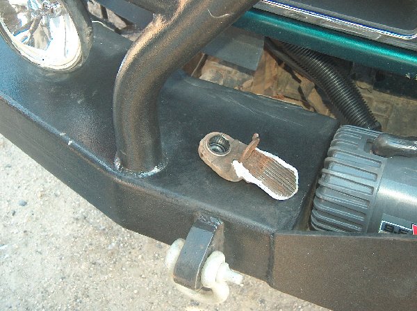 Black off-road bumper with a winch, tow hook, and a detached bracket