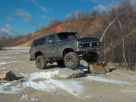 1995 Ford Bronco - Ford Bronco navigating an obstacle course on a dirt and snow-covered trail.