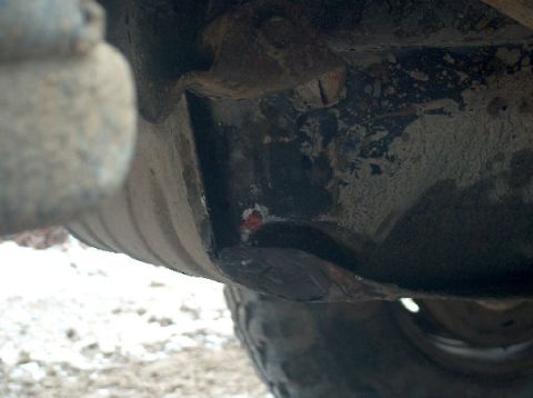 1995 Ford Bronco - Close-up view of the vehicle's undercarriage shows signs of wear and tear.