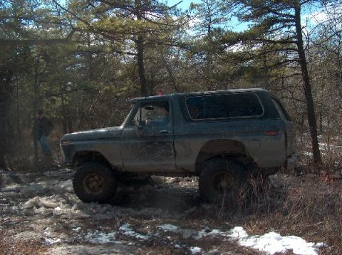 1995 Ford Bronco - This 1978 Ford Bronco is seen navigating a muddy, wooded trail with patches of snow on the ground.