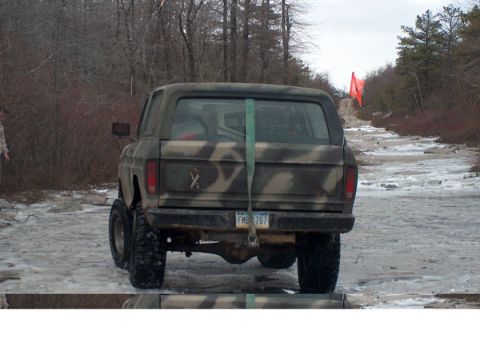 1995 Ford Bronco - Camouflaged SUV with lifted suspension on an icy, wooded road. License plate FMB 707.