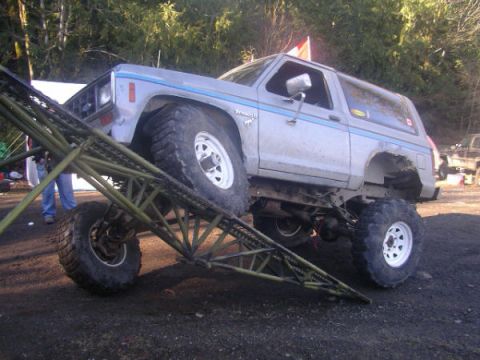 1984 Ford Bronco II - Modified 1984 Ford Bronco II is positioned on a ramp for an off-road event.