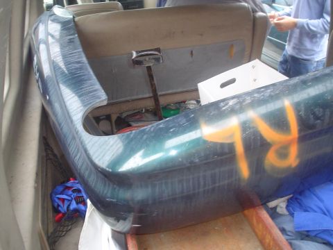 1993 Ford Taurus - A car bumper is stored inside a vehicle, obscuring the interior view.