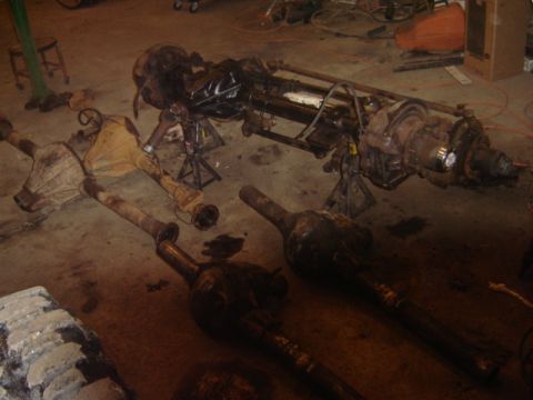 1992 Ford Bronco - Vehicle axles and differential housings are visible on the floor of a workshop.