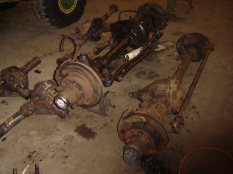 1992 Ford Bronco - Multiple vehicle axles and differential assemblies are visible in this image.