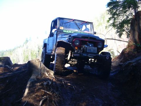 1990 Ford Bronco - This classic Toyota Land Cruiser FJ40 navigates a challenging, muddy off-road course.