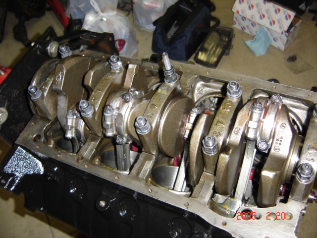 Inverted V8 block showing crankshaft and main caps held by main studs and nuts