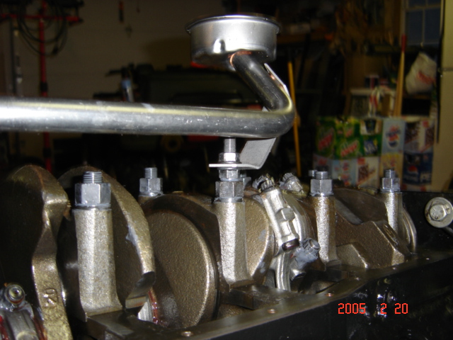 Where oil pump pick up tube mounts to main stud