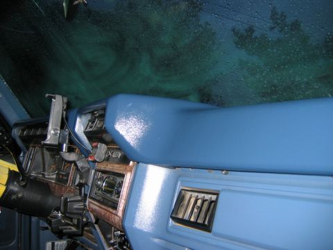 1985 Ford Bronco - Interior view of a 1985 Ford Bronco dashboard, showing the blue dash pad and wood grain accents.