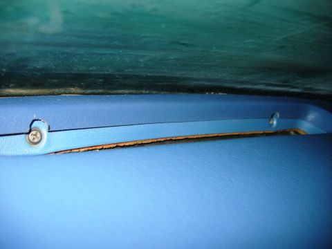 1985 Ford Bronco - This image shows a close-up of the interior dashboard trim of a vehicle, with visible screws and a gap.