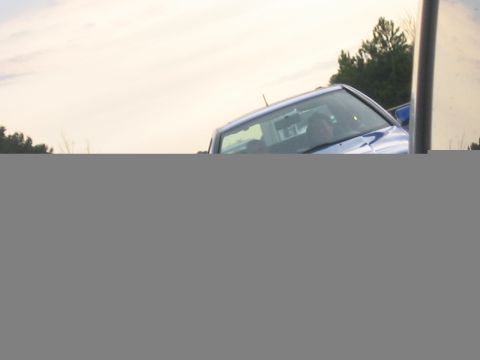 1998 Volkswagen Jetta - Partial view of a blue sedan from the front-right angle.