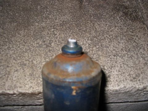 1985 Ford LTD Crown Victoria - Close-up of a rusty blue shock absorber, with a Supermotors.net logo visible in the lower right corner.