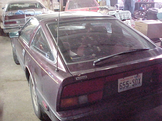 Dark maroon Nissan 300ZX rear view in garage with Washington plate 655-SDX