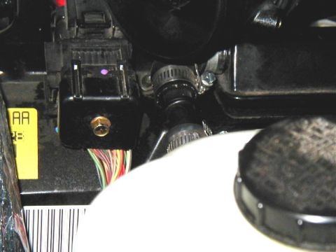 2002 Ford Excursion - Close-up view of a vehicle's engine bay, showing wiring, hoses, and a fluid reservoir. The Supermotors.net logo is visible at the bottom ri…