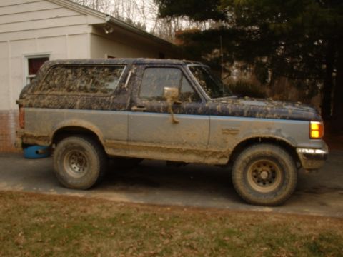 1991 Ford Bronco - This 1991 Ford Bronco is heavily covered in mud after off-road use.