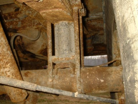 1982 Ford Bronco - Close-up view of heavily rusted undercarriage components, showing significant wear and tear.