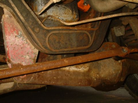 1982 Ford Bronco - The undercarriage of a 1982 Ford Bronco displays significant rust on its suspension and drivetrain components.