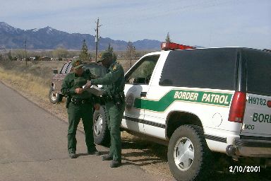 1993 Ford Bronco - Border Patrol officers are seen with two vehicles in a rural area.