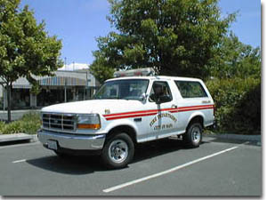 1993 Ford Bronco - White 1993 Ford Bronco with red side stripes, marked for the fire department.