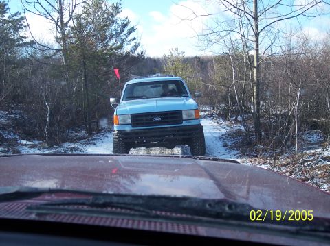 1995 Ford Bronco - A blue Ford truck navigates a snowy trail, with the date 02/19/2005 visible on the lower right.