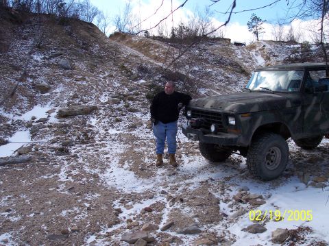 1995 Ford Bronco - A man stands next to a camouflage Ford Bronco in a snowy, off-road environment. The date 02/19/2005 is visible.