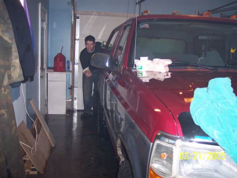 1995 Ford Bronco - 1995 Ford Bronco in garage with man leaning on door. Date stamp visible on headlight.