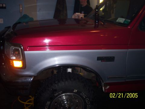 1995 Ford Bronco - A red and silver Ford Bronco is shown from the front three-quarter view, with a date stamp of 02/21/2005.
