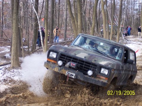 1995 Ford Bronco - This Ford Bronco, likely from the late 1970s, is shown off-roading through a muddy forest trail on February 19, 2005.
