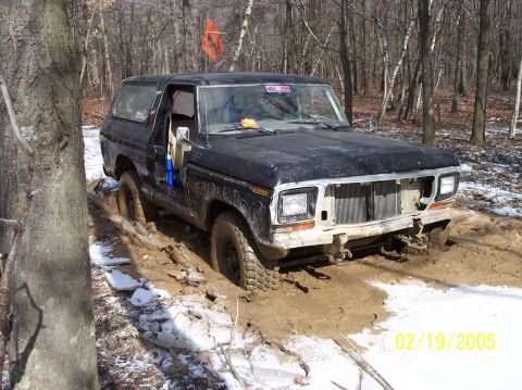 1995 Ford Bronco - Ford Bronco stuck in mud on a wooded trail with snow on the ground. Date stamp visible.