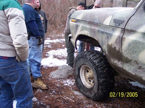 1995 Ford Bronco - Camouflaged Ford Bronco with people gathered around it in a snowy, wooded area.