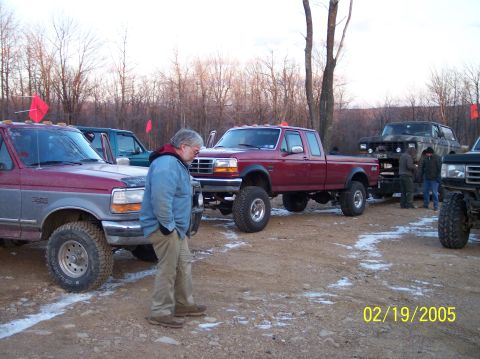 1995 Ford Bronco - A group of modified Ford trucks are gathered outdoors on a winter day, with a date stamp of 02/19/2005.