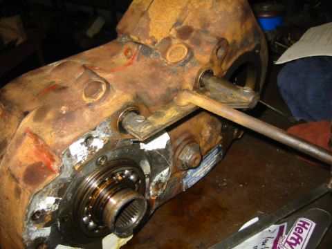 1992 Ford Bronco - This is a close-up view of a heavily rusted transfer case component with visible wear and tear.