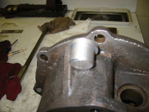 1992 Ford Bronco - A cast metal part, possibly from a vehicle's drivetrain, is shown on a workbench.