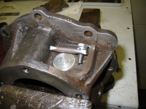1992 Ford Bronco - A metal component, possibly from a vehicle's drivetrain, is secured in a vise for work.