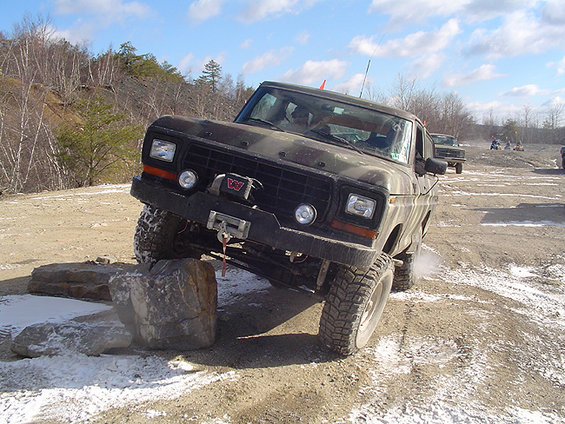 Camouflage Ford Bronco navigating rocky terrain