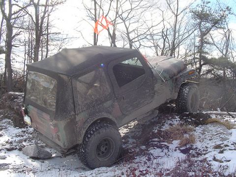 1995 Ford Bronco - Jeep Wrangler TJ navigating snowy off-road conditions.