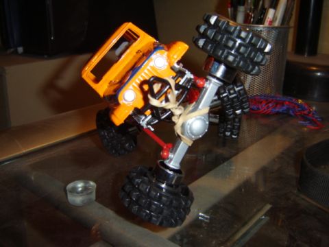 1992 Ford Bronco - Modified toy off-road vehicle with oversized tires and custom suspension.