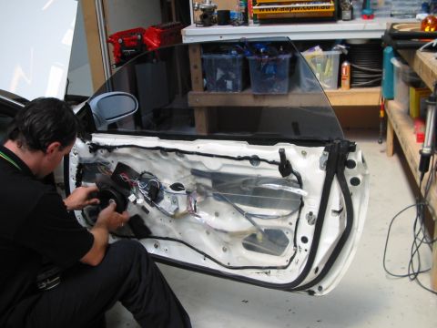 1994 Ford Probe - Car door interior exposed during speaker installation.