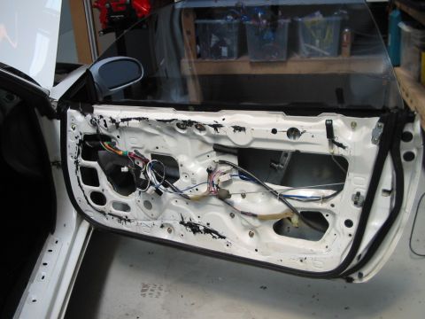 1994 Ford Probe - The interior of a car door is exposed, revealing wiring and internal mechanisms.