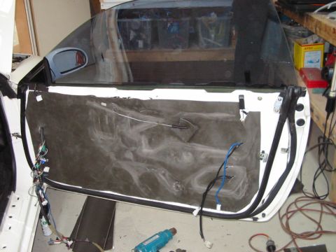 1994 Ford Probe - The interior of a car door is exposed, revealing wiring and insulation material.