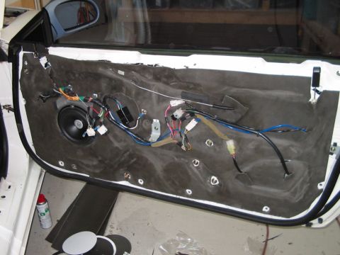 1994 Ford Probe - Interior of a car door with the panel removed, revealing the speaker and wiring.