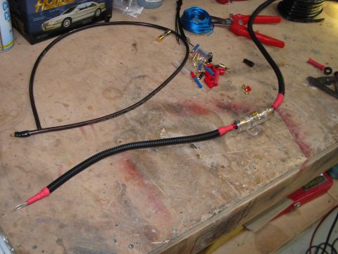 1994 Ford Probe - Car audio wiring components, including a fuse holder and connectors, are laid out on a wooden surface.