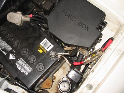 1994 Ford Probe - Close-up of a car's battery and fuse box, showing electrical components and wiring.