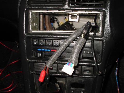 1994 Ford Probe - Close-up of car stereo wiring and dashboard controls, showing disconnected cables.