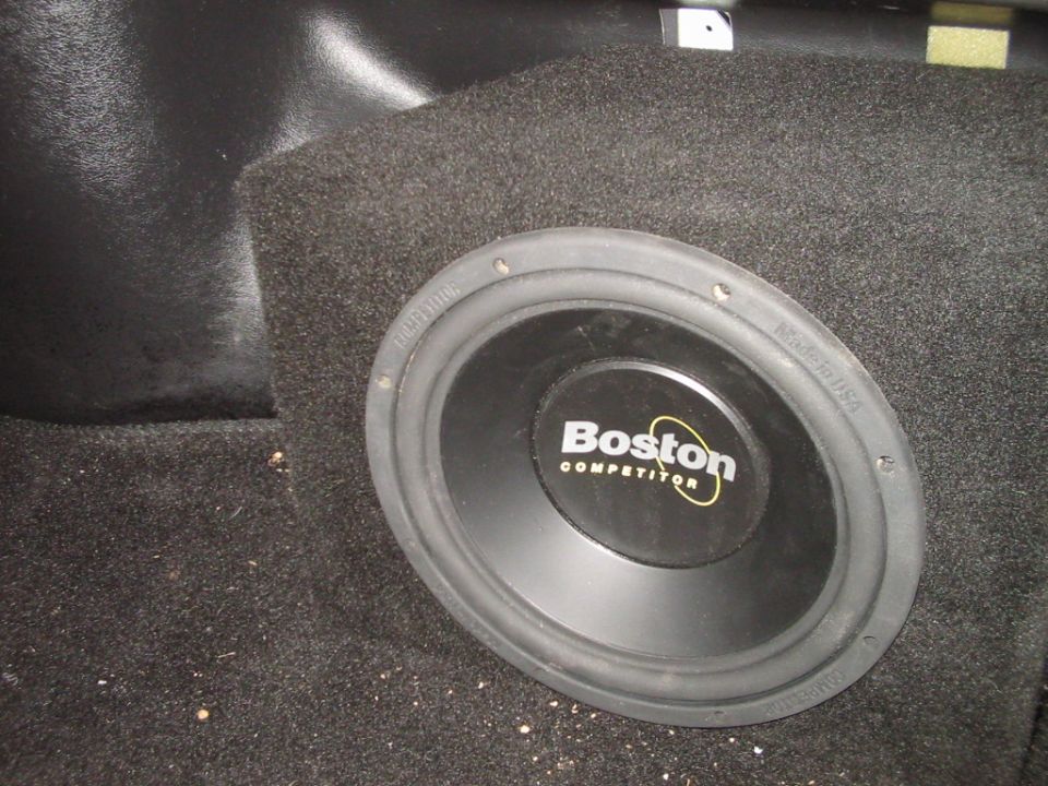 Subwoofer in carpeted enclosure, visible Boston Competitor logo, "Made in USA" text