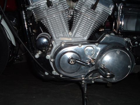 1995 Mercury Grand Marquis - The V-twin engine of a motorcycle is shown in detail, highlighting its mechanical components.