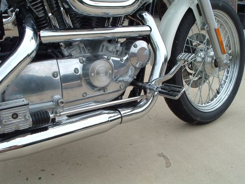 1995 Mercury Grand Marquis - Close-up view of a motorcycle's engine, exhaust, and front wheel assembly.