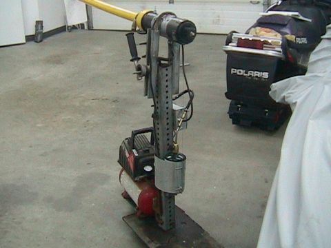 1981 Chevrolet C/K Pickup - A custom-built apparatus with a yellow arm and an air compressor is shown in a garage setting.